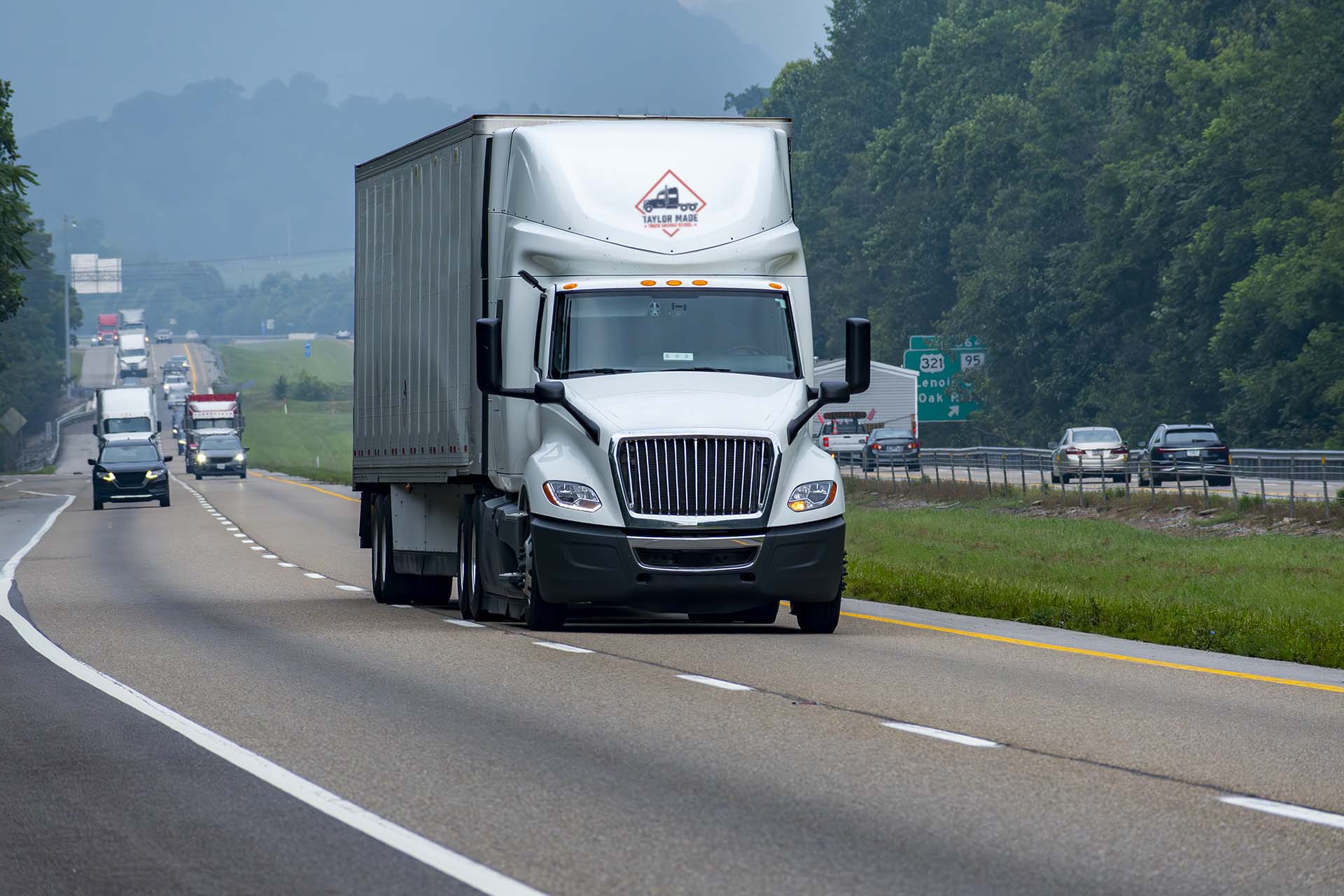 Taylor Made TDS conventional truck on a Pacific Northwest highway